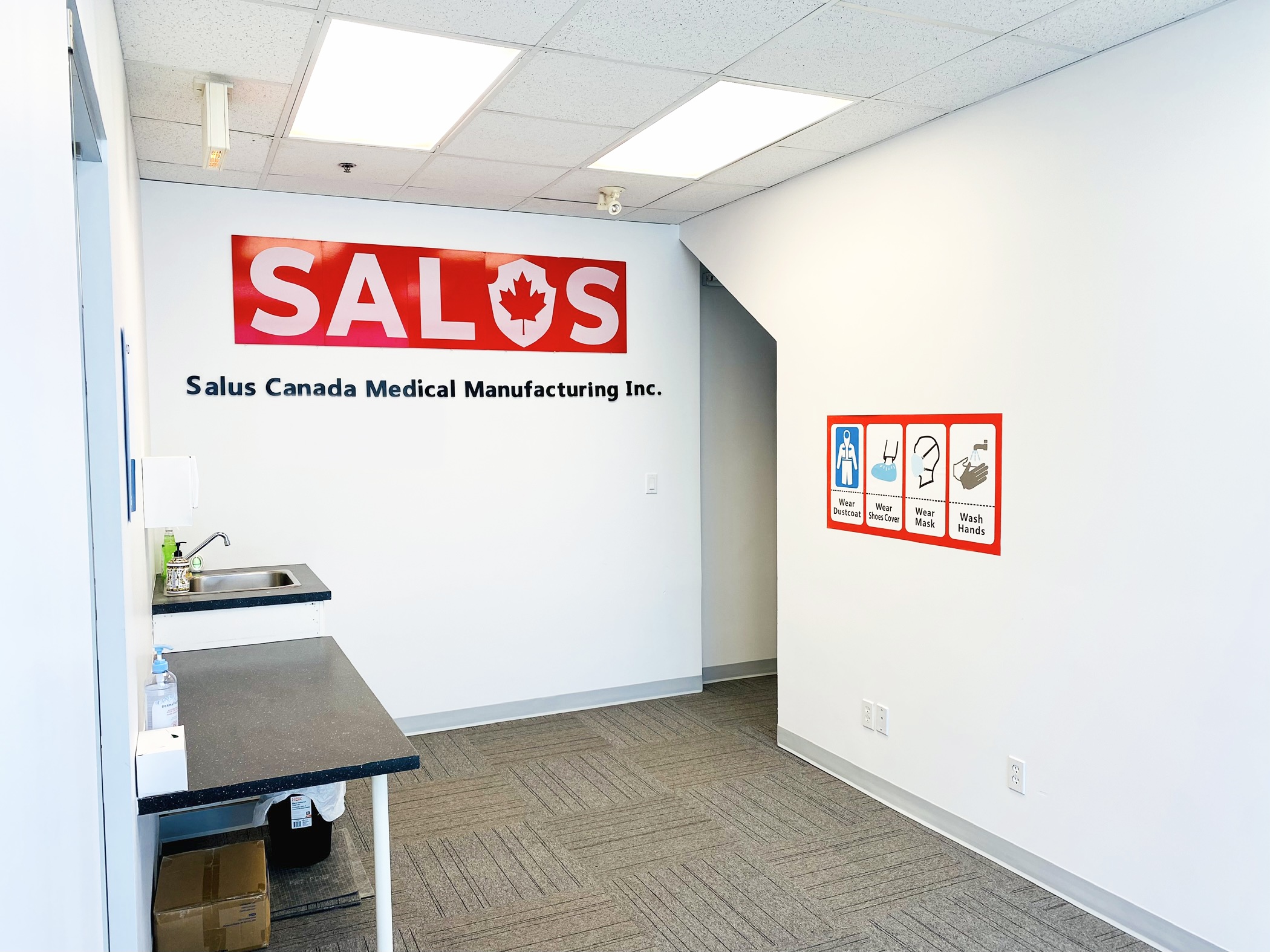 Salus facility entry with gowning station, SALUS sign and protocol board
